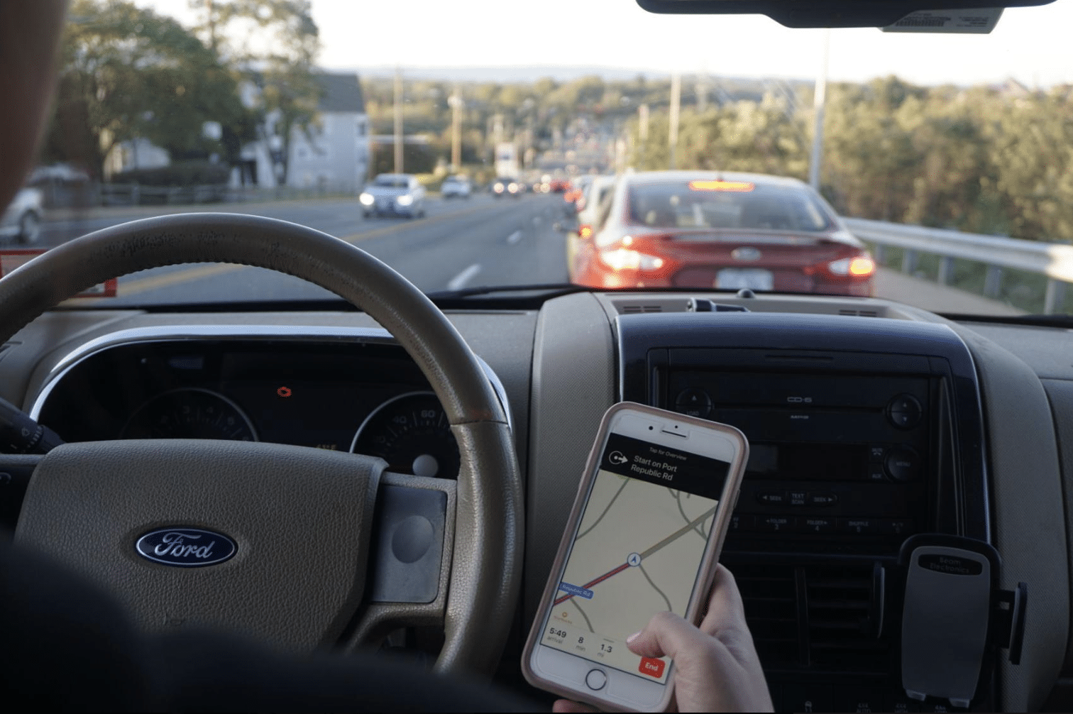 inside car with phone in hand