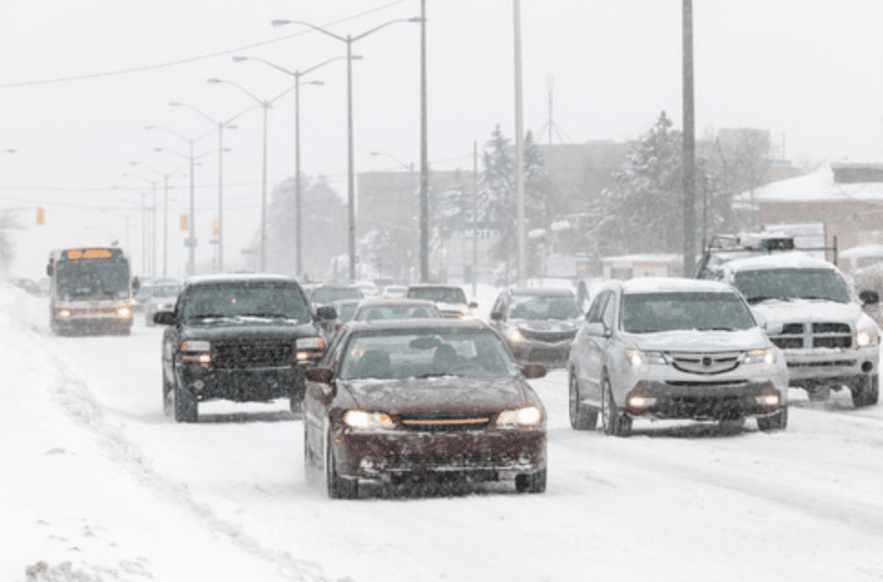 cars driving on snowing road