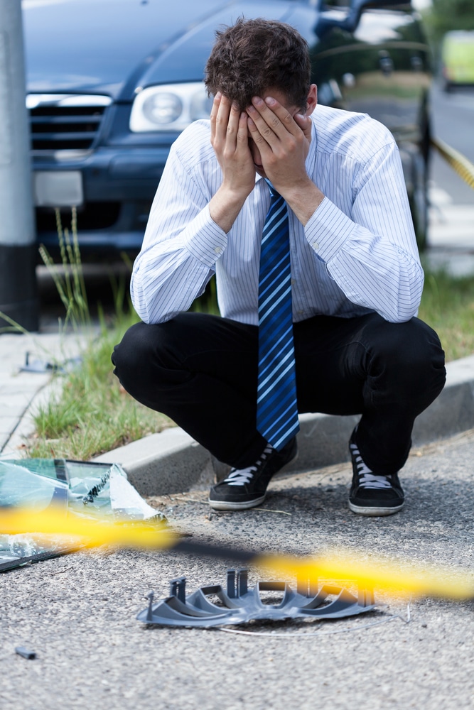 Elegant man crying at accident scene