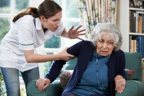 Nursing home worker abusing an elderly woman