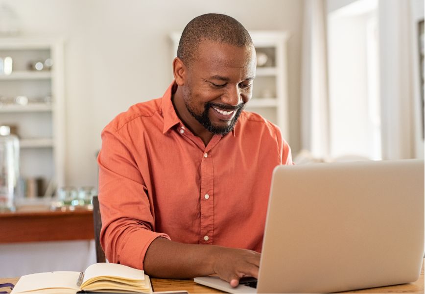 Happy guy looking at laptop