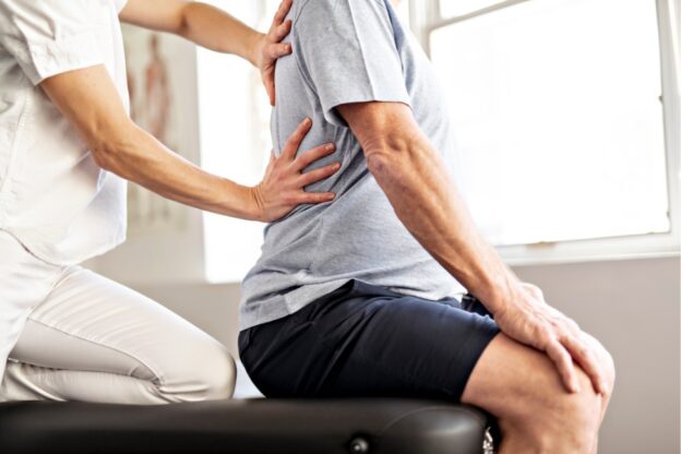 Doctor checking a patient's back