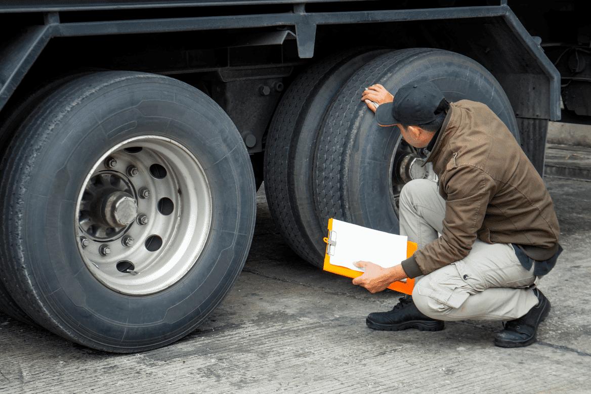truck driver inspects damage after accident