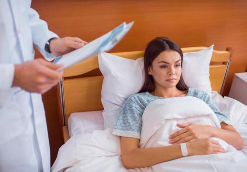 injured-woman-in-hospital-bed-after-a-medical-procedure-from-a-negligent-doctor-in-cumming